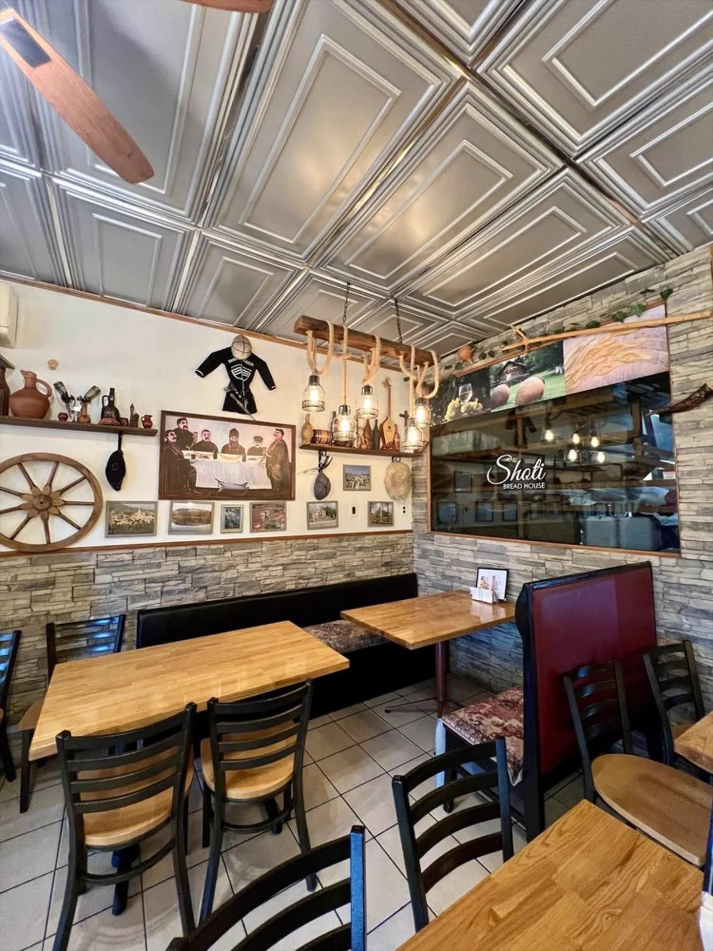 Dining room with tin ceiling, rope lanterns and Georgian folk art