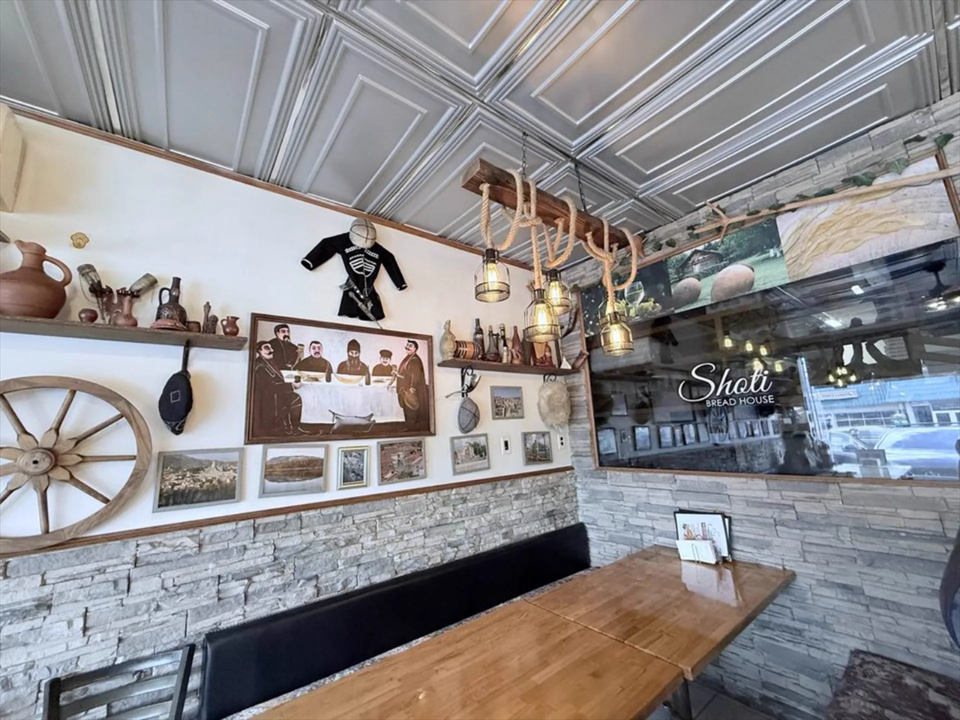 Wagon wheel and qvevri jugs on the wall