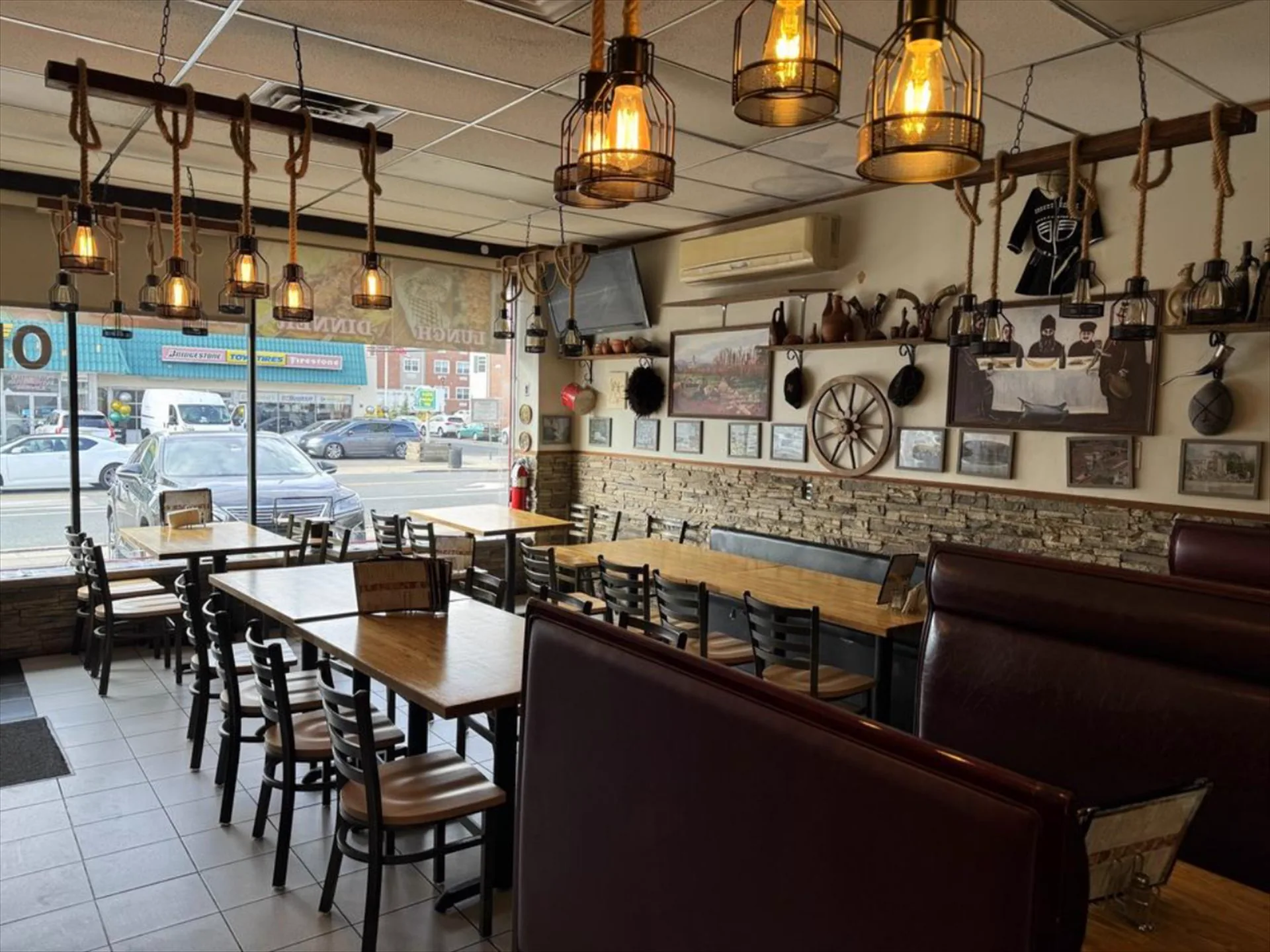 Window-side tables under Edison lanterns