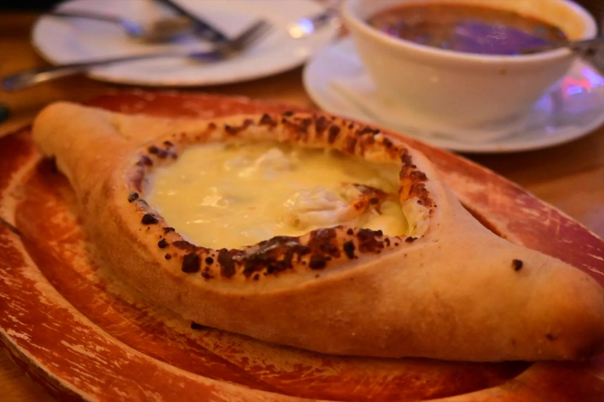 Adjaruli khachapuri, boat-shaped bread with molten cheese and egg